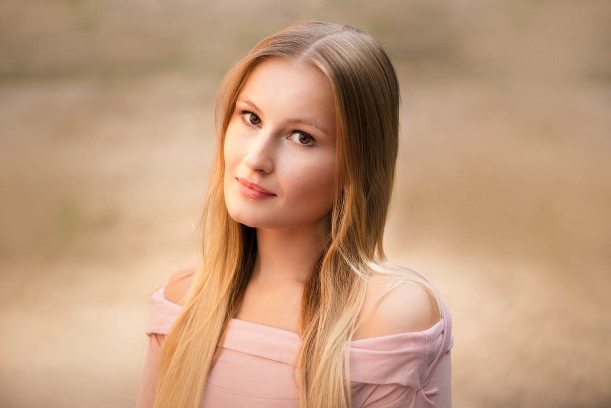 Professional headshot of a female actor headshot in pink jumper