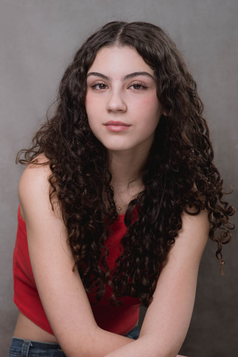 dark haired actor in red top
