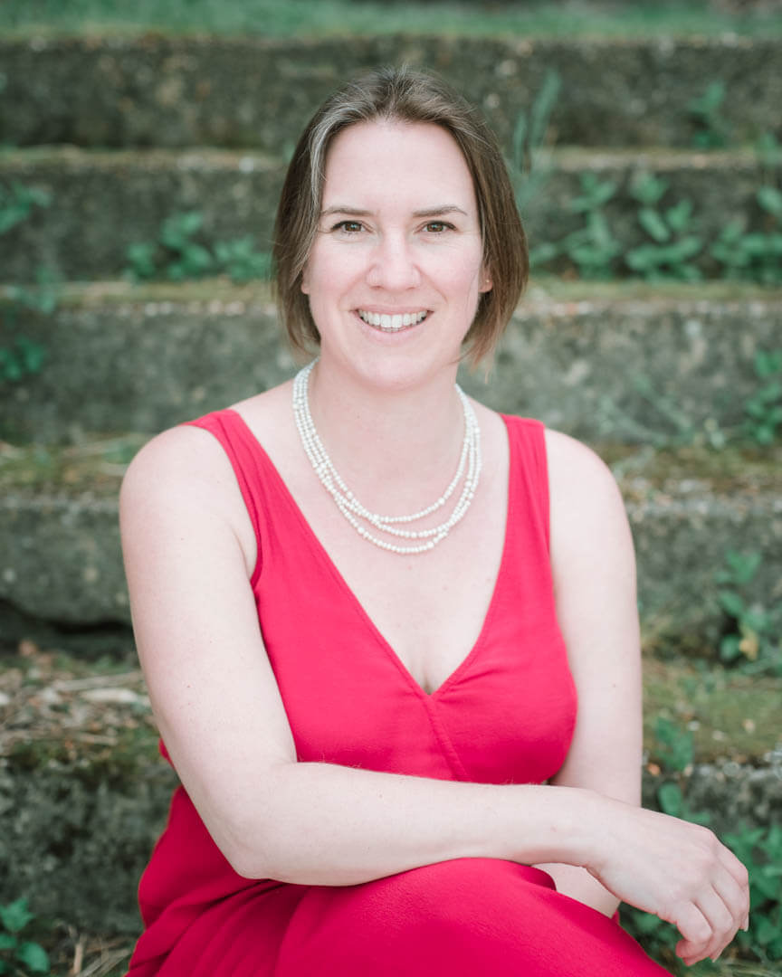 Joy coach smiling in red dress