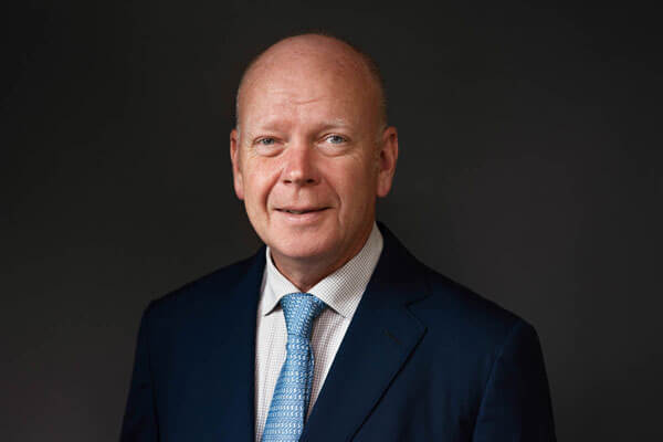business man smiles for CEO headshot Teen headshot for Client Stories by an Isle of Wight Headshot Photographer