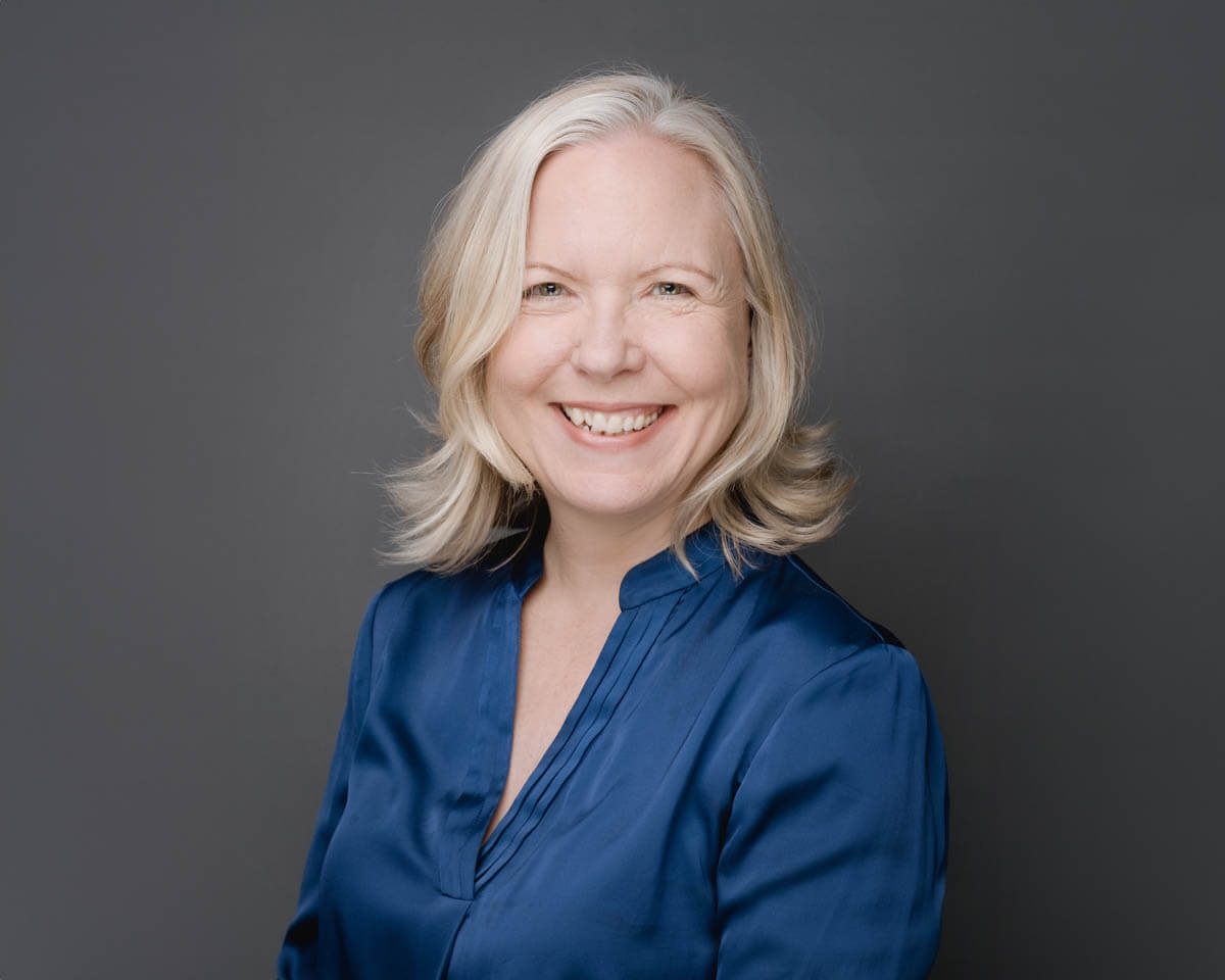 Smiling female founder and CEO of a wellness company wearing a blue blouse